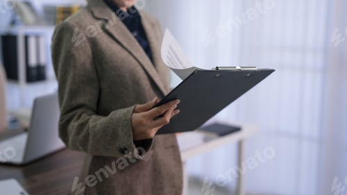 Preview: Professional Businesswoman Lawyer Holding Clipboard Reviewing Legal Documents Report Standing Office