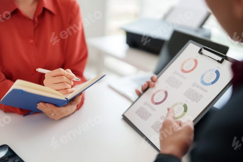 Preview: Business colleagues discuss financial data analyze market trends take notes collaborate strategize i