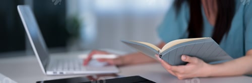 Preview: Asian women reading medical book studying research at desk with laptop computer for professional dev