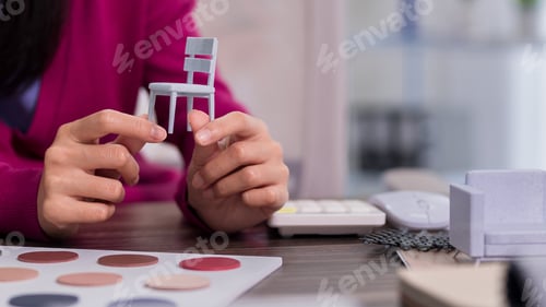 Preview: Interior Designer Hands Holding Miniature Chair Model Selecting Color Palette Material Samples Creat