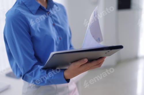 Preview: Business Professional Holding Digital Tablet Reviewing Document Report Data Analysis Reading Informa
