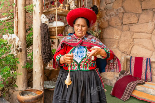 Preview: Peruvian woman making wool yarn with handmade spindle