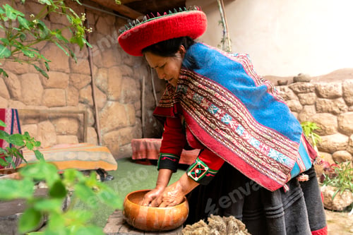 Preview: Peruvian female artisan washing wool fibers in rustic rural courtyard