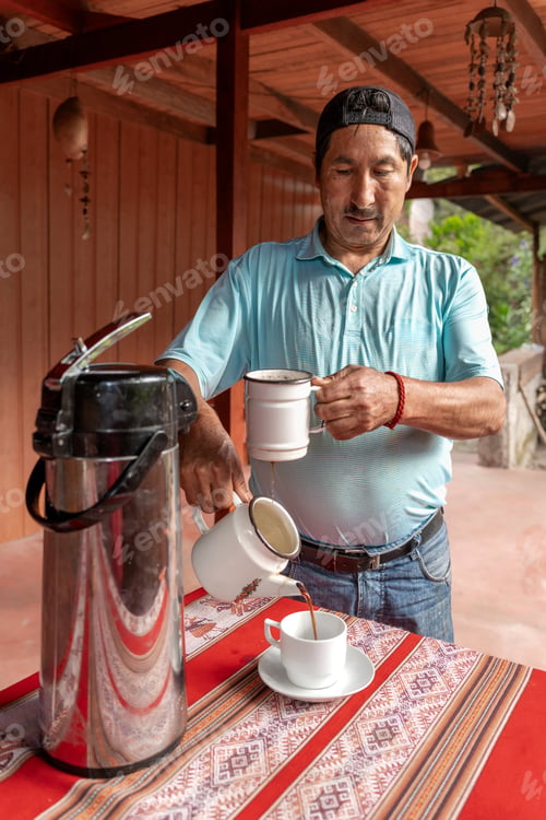 Preview: Latin American man pouring fresh homemade coffee at a rustic outdoor terrace