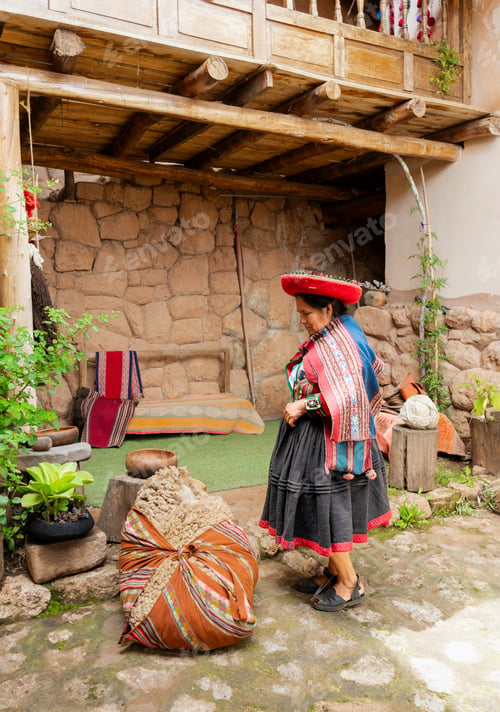 Preview: Indigenous Andean woman in traditional Peruvian clothing standing in a rustic courtyard