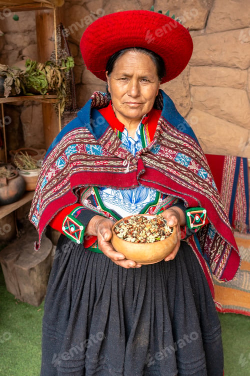 Preview: Traditional Peruvian woman holding bowl of dried natural herbs