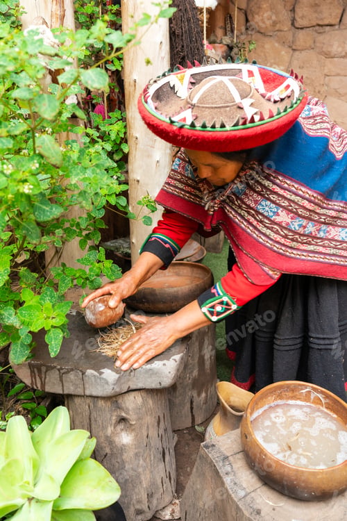 Preview: Indigenous Andean woman preparing natural fibers in rustic village courtyard