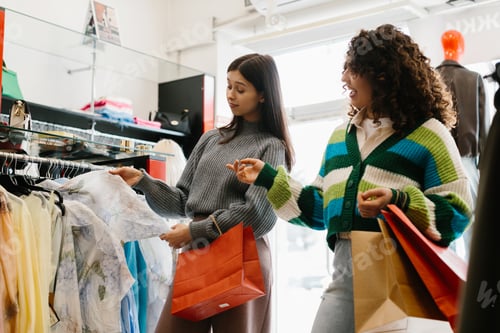 Preview: Young women shopping for clothing in store