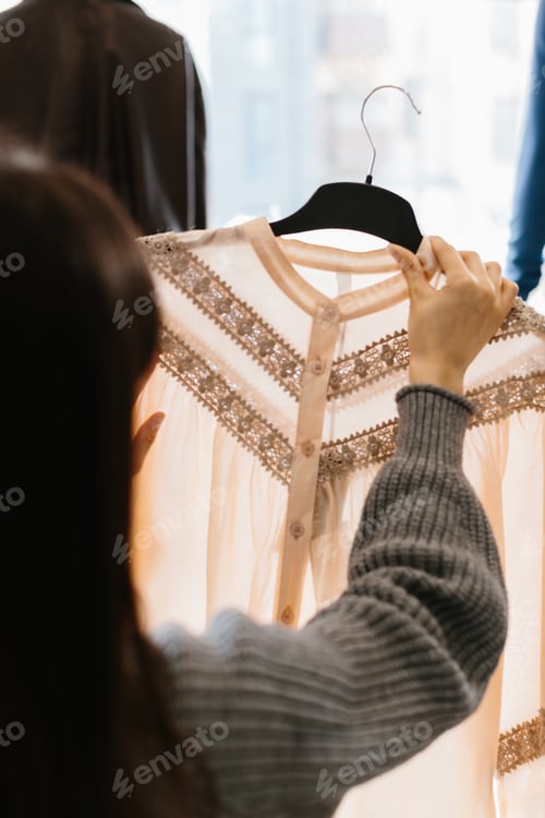 Preview: Woman choosing elegant blouse for shopping