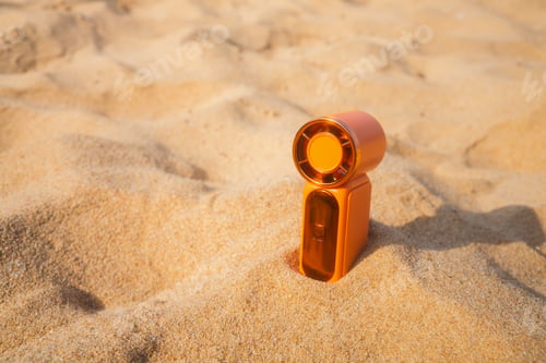 Preview: Portable handy fan on the beach and the background is the sea and the sky in summer.