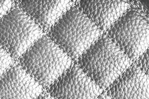 Preview: Macro Of White Quilted Leather Texture Background With Stitched Pattern And Shining Metal Effect