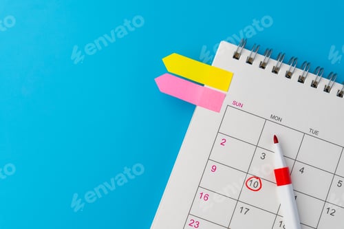 Preview: A spiral desk calendar with a red circle marks and red marker.