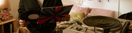 Preview: Header of Man Holding Vinyl Record at Home for Music Lifestyle Marketing