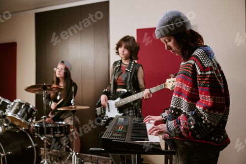 Preview: Teenage Girls Playing Keyboard Bass and Drums during Band Rehearsal