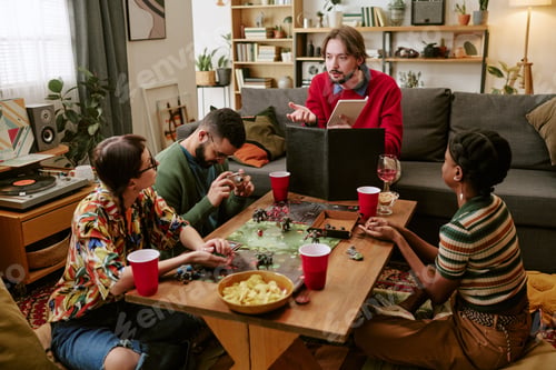 Preview: Diverse Adults Playing Tabletop Roleplaying Game during House Party