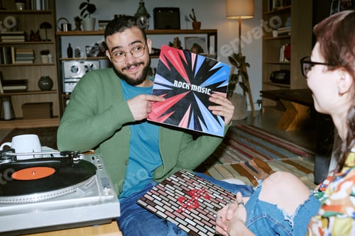 Preview: Adult Man Showing Rock Music Vinyl Record during Home Listening