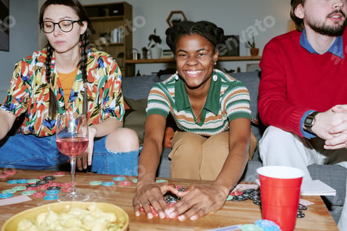 Preview: Black Woman Playing Poker with Friends during Home Game Night