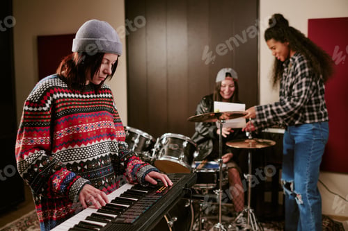 Preview: Teenage Girls Preparing Keyboard and Drums for Band Practice