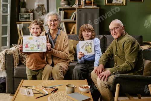 Preview: Portrait of Senior Couple with Children Showing Drawings at Home