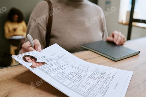 Preview: Middle Aged Woman Submitting Application Form at Reception Desk