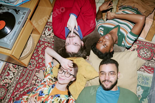 Preview: Multiethnic Adult Friends Relaxing on Floor during Vinyl Listening