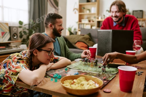 Preview: Diverse Adults Playing Tabletop Strategy Game during Home Gathering