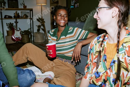 Preview: Black Adult Woman Socializing with Friends during House Party