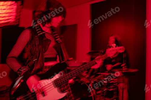 Preview: Teenage Girl Playing Bass Guitar during Girls Band Studio Session