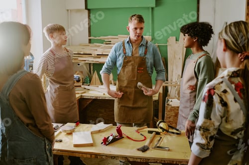 Preview: Adult Man Instructing Diverse Teenagers in Woodworking Class