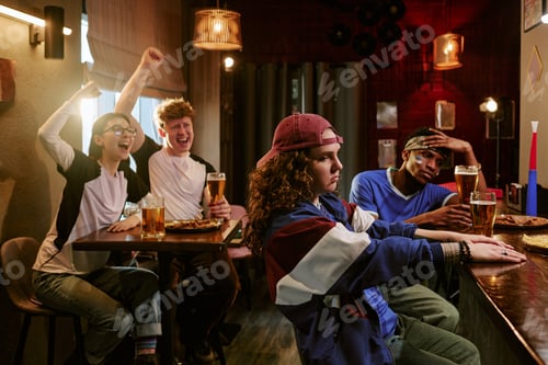 Preview: Diverse Friends Watching Sports in Bar with Winning and Losing Reactions