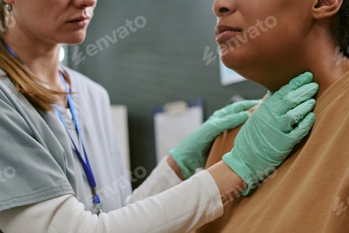Preview: Black Woman Receiving Thyroid Examination during Medical Checkup