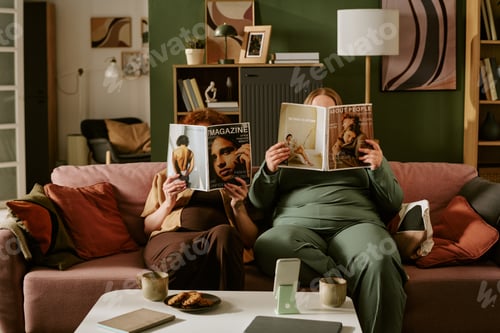 Preview: Plus Size Women Reading Magazines during Relaxing Evening at Home