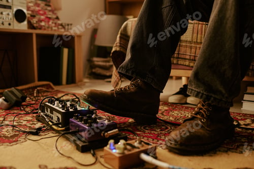 Preview: Musician Playing Guitar Effects Pedals at Home Studio