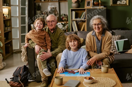Preview: Portrait of Senior Couple with Children Posing at Home