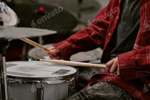 Preview: Teenager drummer playing drum kit during music practice, showing rhythm training and creative skill
