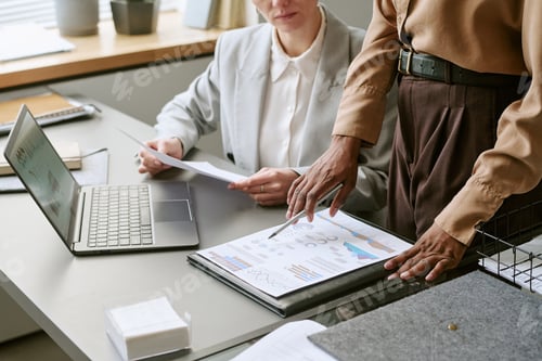 Preview: Businesswomen Reviewing Financial Reports during Office Meeting