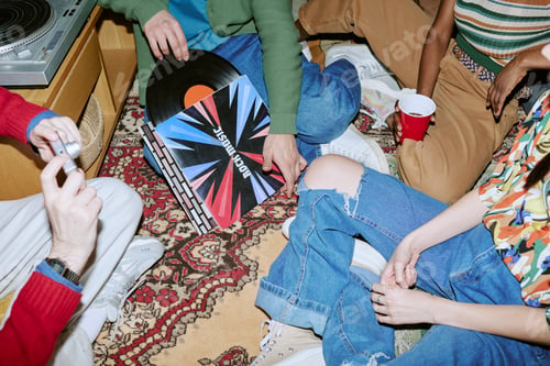Preview: Diverse Adults Listening to Vinyl Records at Casual Home Gathering