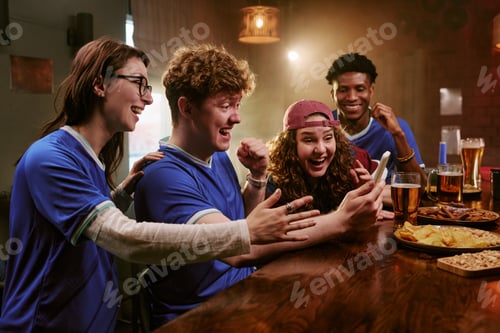 Preview: Multiethnic Friends Celebrating Sports Win While Watching Smartphone