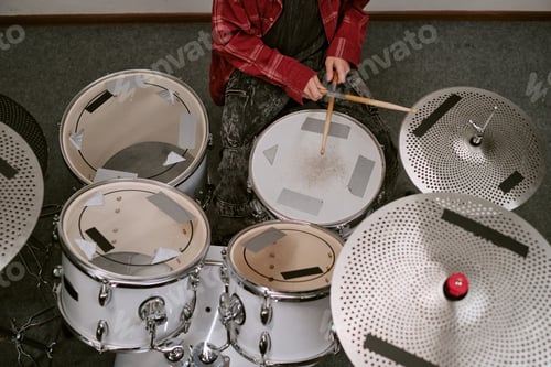 Preview: Teenager playing drum kit during music practice, showing rhythm training and creative learning. Usef