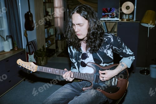 Preview: Man Crafting Guitar Hooks at Home for Music Marketing