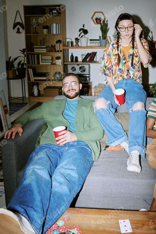Preview: Adult Friends Relaxing at House Party with Drinks and Card Game