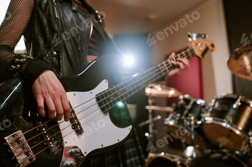 Preview: Teenage Girl Playing Bass Guitar during Music Studio Session