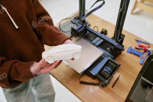 Preview: Teen Girl Holding 3d Printed Car Model for Prototyping