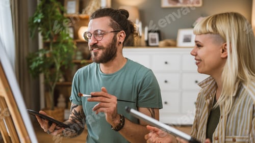 Preview: Couple Man and Woman Paint on Canvas on Easel at Home Leisure Hobby