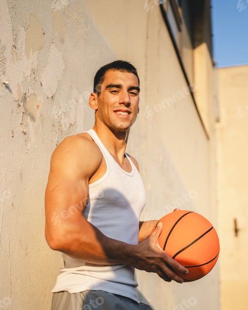Preview: Portrait of strong athlete man hold basketball ball wear white a-shirt
