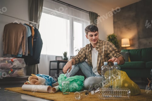 Preview: One Man Young Adult Recycle at Home Sort Waste Plastic Paper and Glass