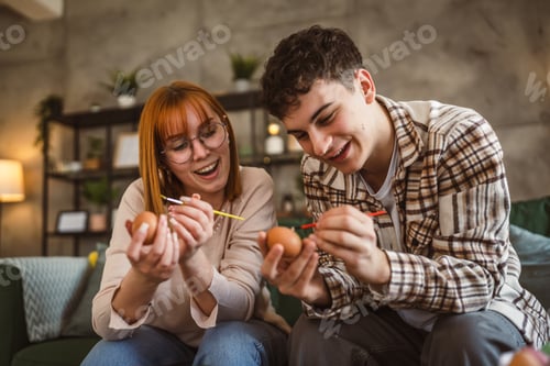 Preview: Young Man and Woman Couple or Brother and Sister Paint Easter Eggs