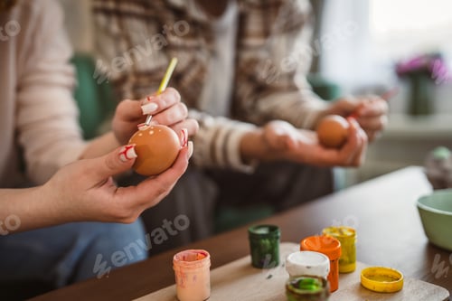 Preview: Young Man and Woman Couple or Brother and Sister Paint Easter Eggs