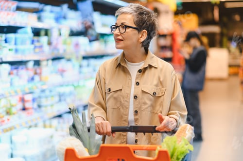 Preview: Woman buying groceries for healthy food at supermarket