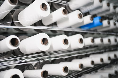 Preview: White polypropylene yarn bobbins weaving in textile factory